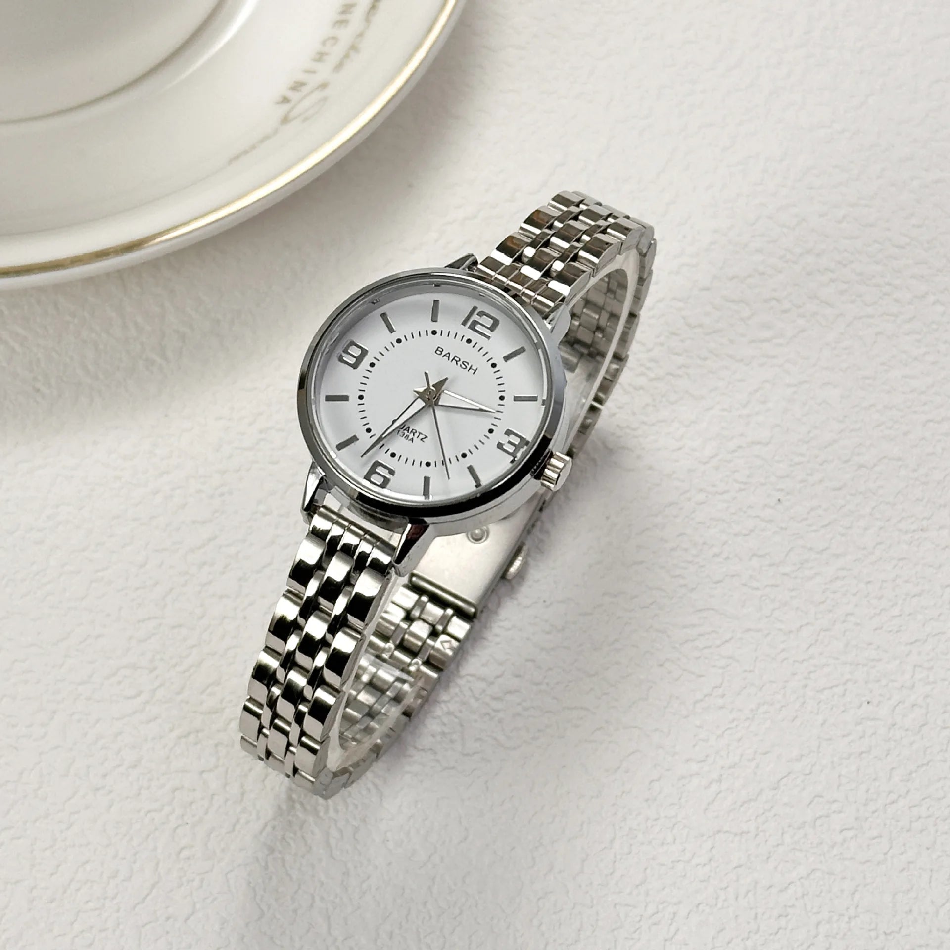 Elegant women’s silver watch with a polished stainless steel bracelet and clean white dial. Timeless, refined, and perfect for everyday luxury